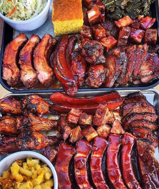 Assortment of delicious food including Ribs, Mac and Cheese, and sides